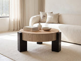 Alba 31.5-Inch Round Parquet Wood Veneer Storage Coffee Table styled with books, a vase and a stone bowl in front of a cream sofa in a bright plaster room