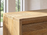 Close-up of the Alberobello Low Mango Media Console: the top corner: the natural mango plank pattern on the top and the door below