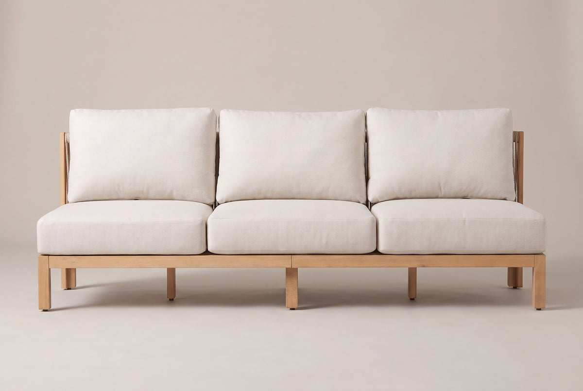 The Alcamo sofa seen straight from the front: three seat cushions, three back cushions and the light teak acacia base on five front legs