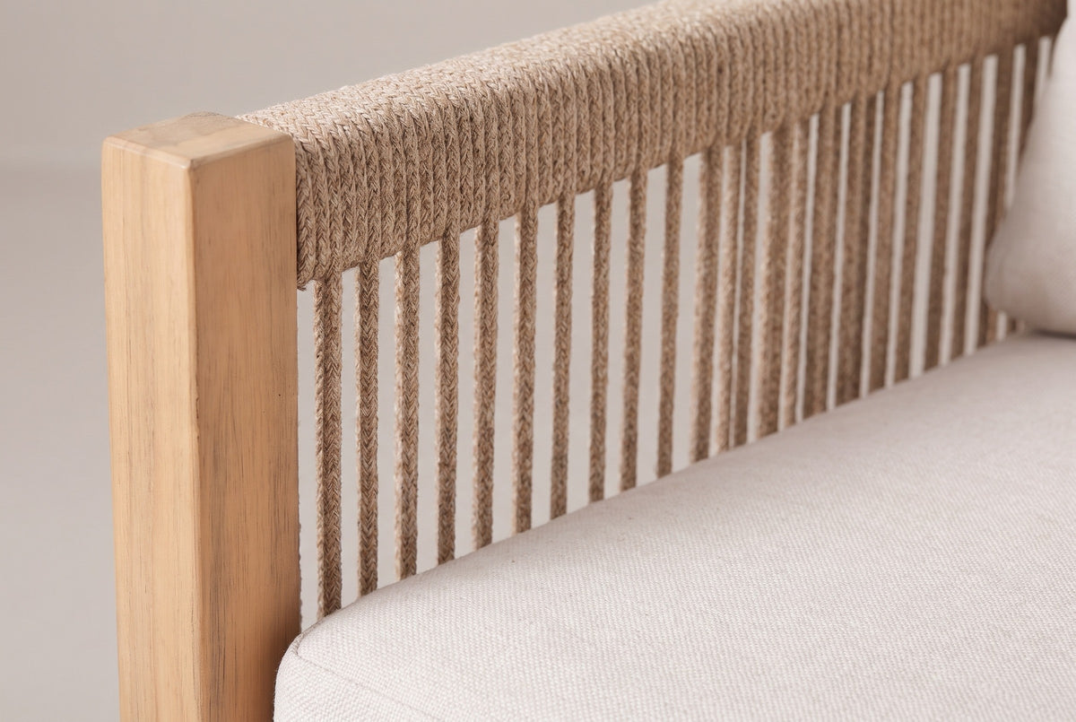 Close-up of the braided beige rope back and a light teak acacia post of the Alcamo sofa