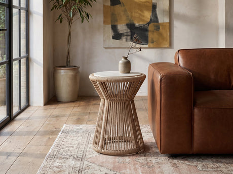 Alessano Rope Hourglass Side Table beside a leather sofa in an industrial loft
