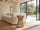 Alessano Rope Hourglass Side Table beside a linen sofa in a poolside villa