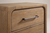 The top corner of the Alghero nightstand: rounded frame post and top rail, the top drawer with a rounded upper corner and a dark bronze bar pull