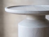 Close-up of the Aliano Whitewashed Mango Tray-Top Side Table: the tray top over the turned neck and shoulder