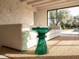Alliste Blown Glass Hourglass Side Table beside a linen sofa in a poolside villa