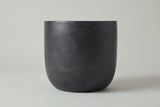The Altavilla side table seen straight from the side: straight upper sides curving in to a smaller flat base