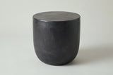 The Altavilla matte black concrete side table, three-quarter view on a light studio backdrop