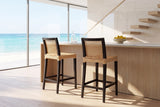 Altilia Open-Weave Rattan and Mahogany Counter Stool in an oceanfront glass house