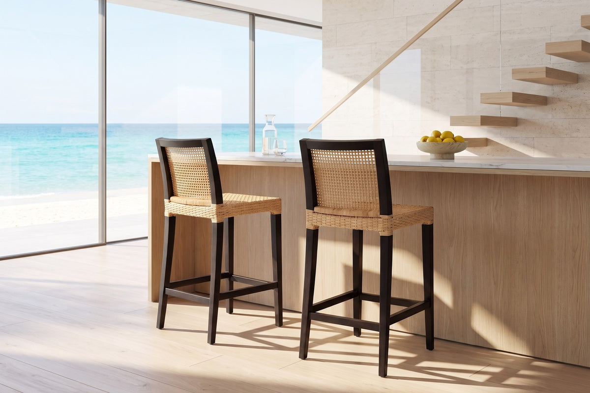 Altilia Open-Weave Rattan and Mahogany Counter Stool in an oceanfront glass house