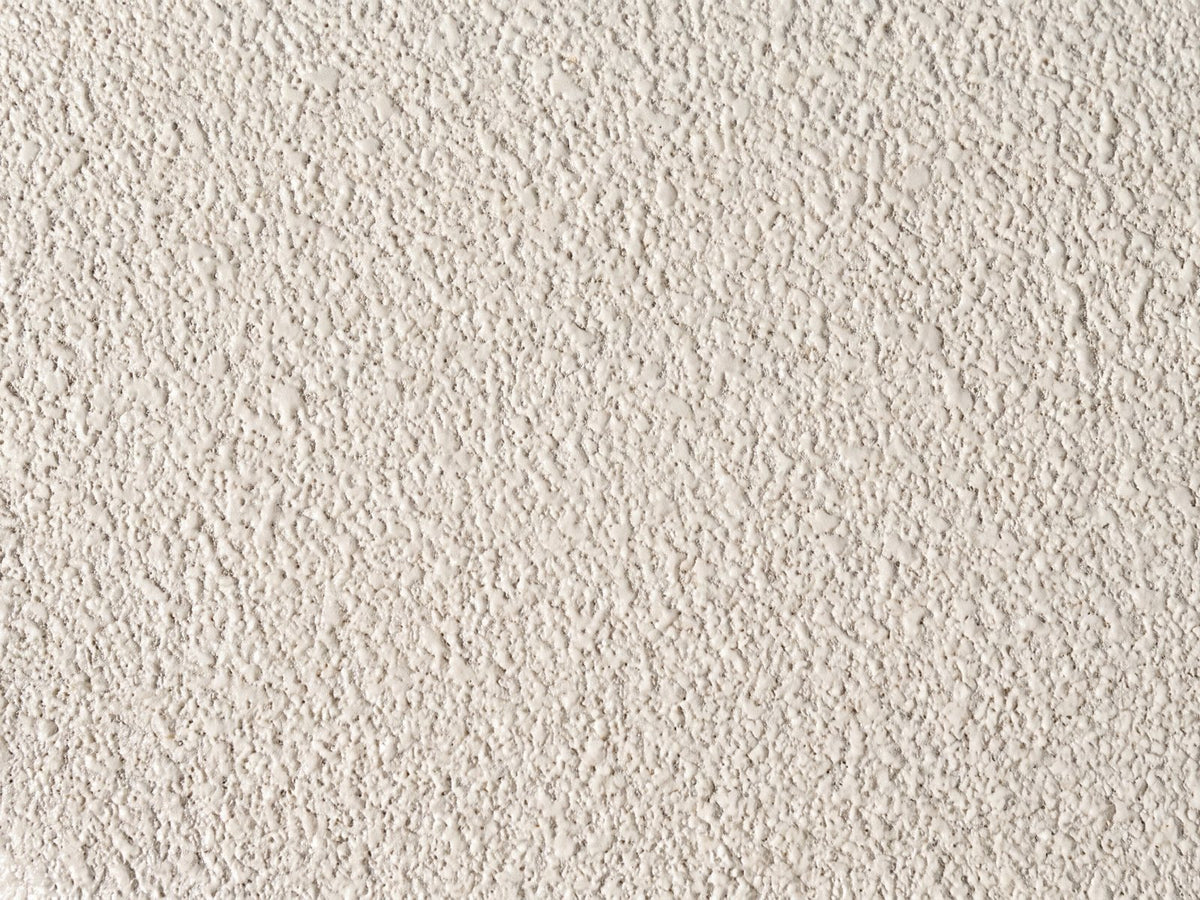 Close-up of the Altomonte Cream Fiberglass Stacked Side Table: the cream sand-textured finish of the top