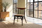 Amendolara Spindle-Back Mahogany and Rattan Dining Chair in a city loft