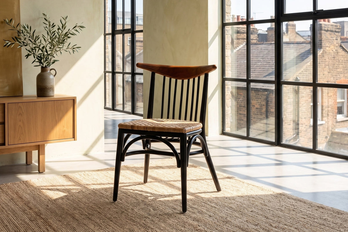 Amendolara Spindle-Back Mahogany and Rattan Dining Chair in a city loft