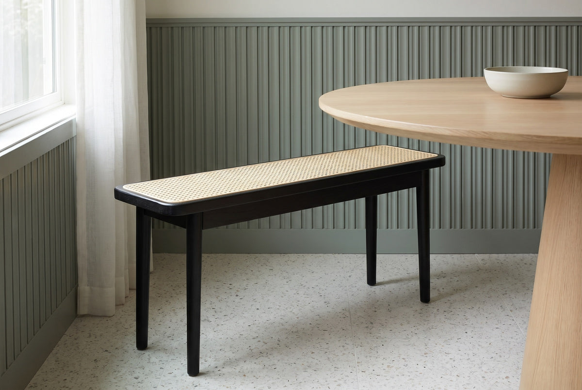 Anagni bench beside a round white oak dining table in a Portland dining nook with a sage-green fluted wall and a terrazzo floor (table not included)