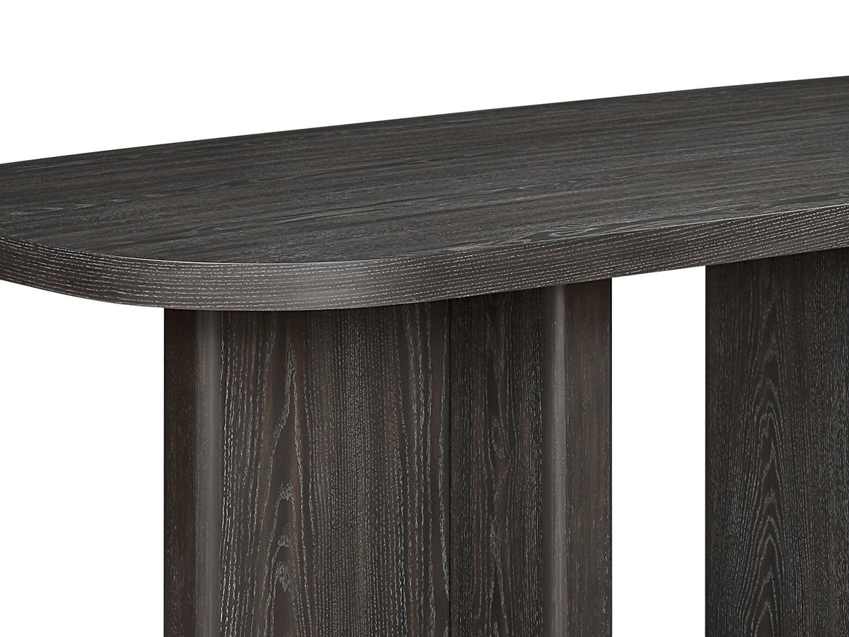 Close-up of the Anticoli 78-Inch Ebony Oak Pedestal Dining Set with 4 Boucle Armchairs: a T-shaped slab pedestal under the thick edge of the ebony oak top