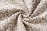 Close-up of the light beige boucle on the Anversa bed: small tight loops of beige, oatmeal and off-white, gathered in a soft swirl