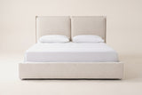 Anversa bed in beige boucle with a white mattress and pillows (not included), straight front view: two headboard panels over a low upholstered base