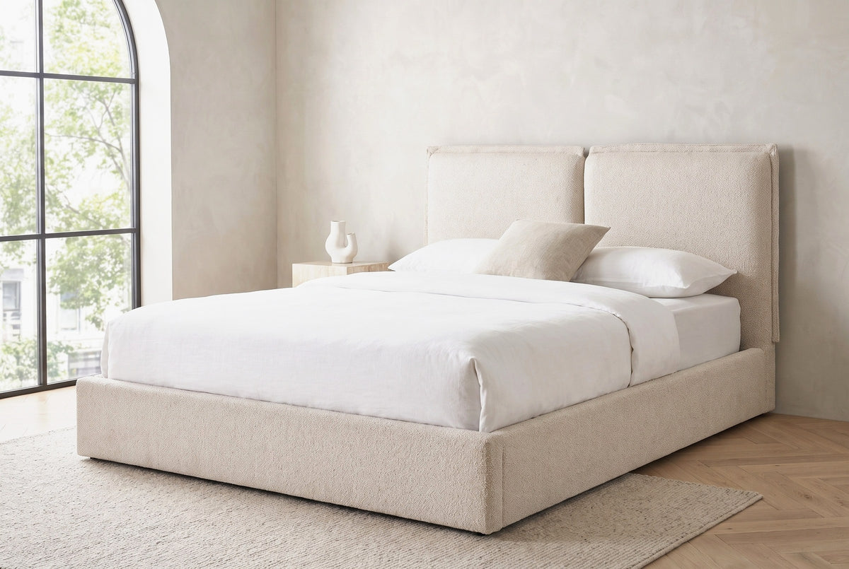 Anversa bed under a tall arched window in a Tribeca loft bedroom