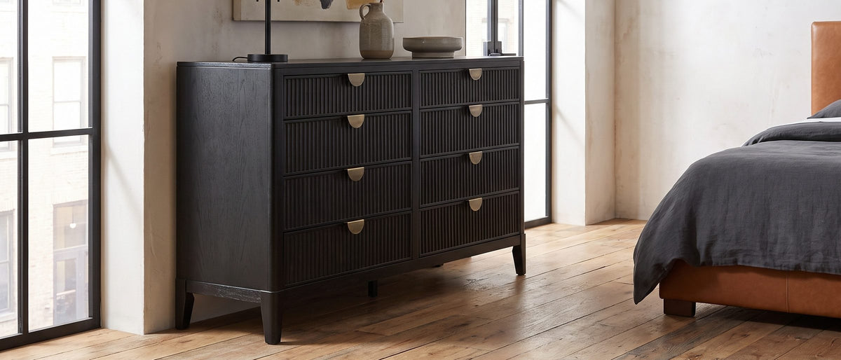 Agordo 66-Inch Black Fluted 8-Drawer Dresser in the room