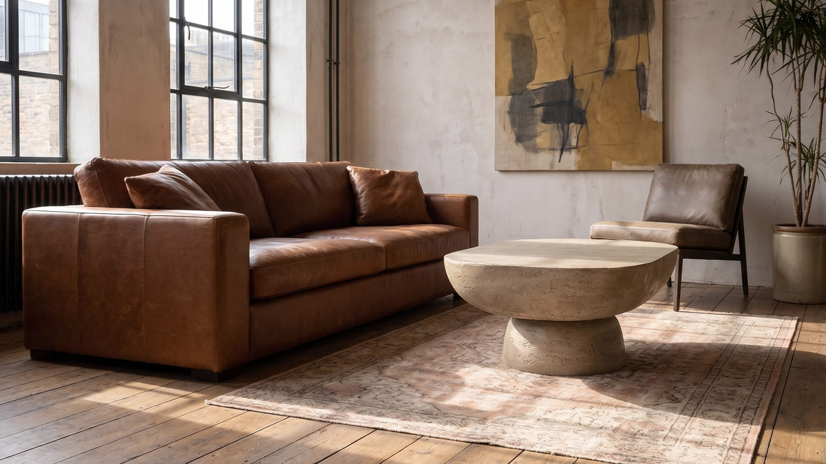 Sand-toned, rough, and low. - Asiago Faux Travertine Oval Mushroom Coffee Table