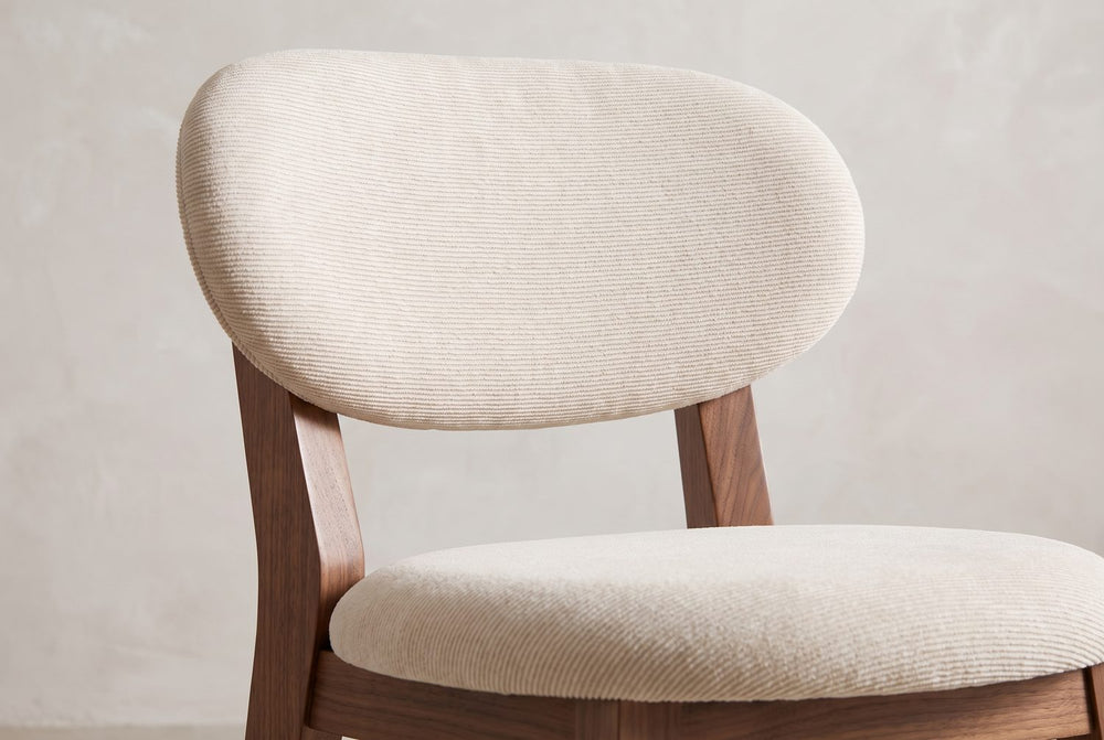An oval back, a round seat