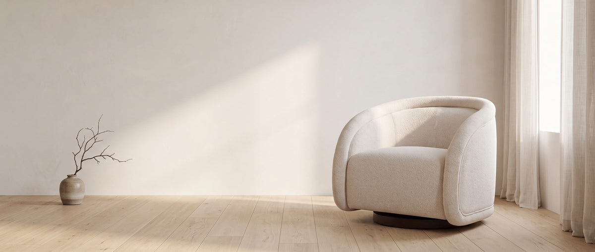 The Carina swivel chair in a sunlit room beside an empty plaster wall
