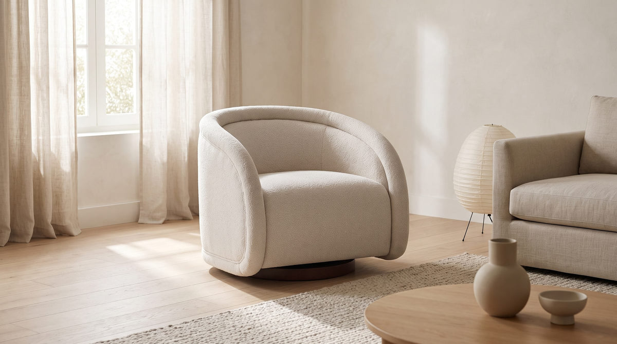 The Carina chair in a living room beside a sofa, an oak coffee table and a paper lamp