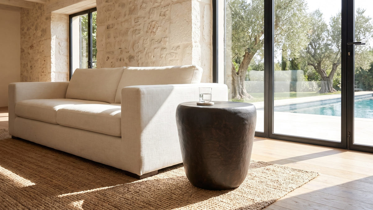 A dark shape in a light room. - Cervara Rustic Bronze Metal Drum Side Table