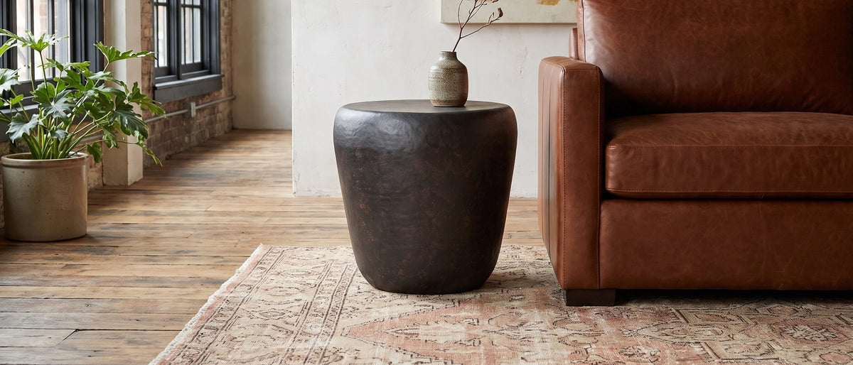 Cervara Rustic Bronze Metal Drum Side Table in the room