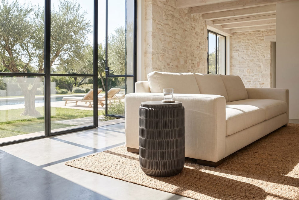 A carved cylinder beside the sofa