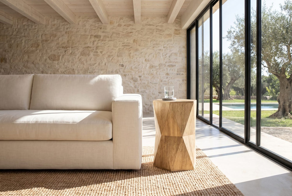 A faceted hourglass beside the sofa