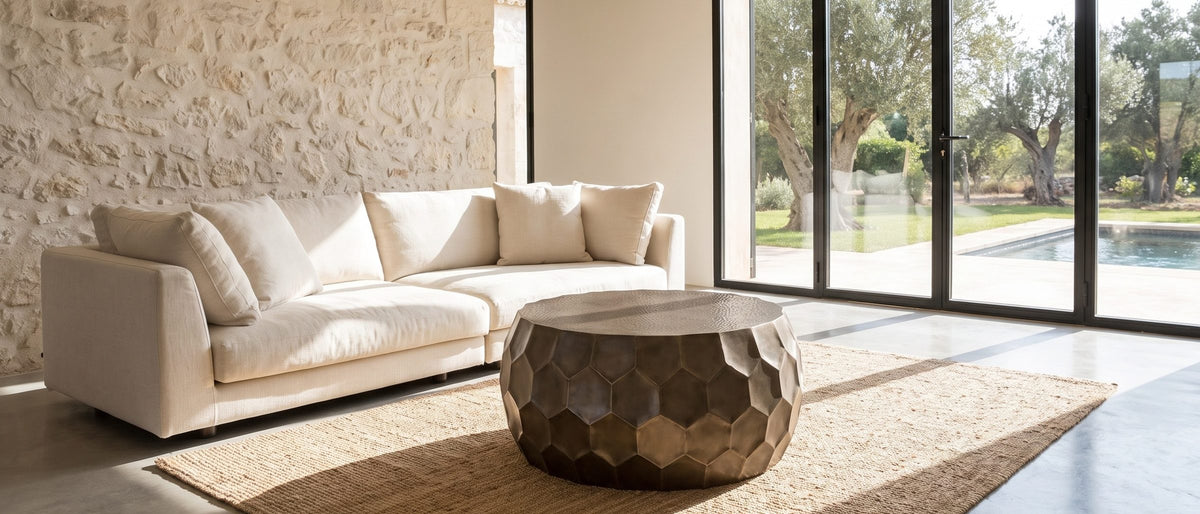 Gavi 32-Inch Round Antique Bronze Faceted Aluminum Drum Coffee Table in the room