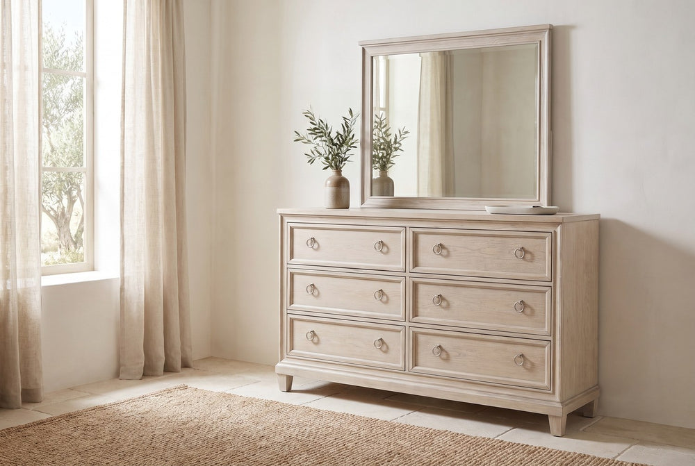 Dresser under a framed mirror