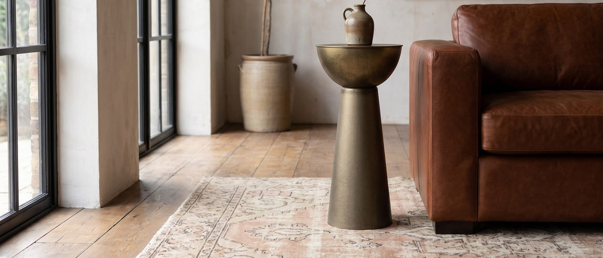 Melpignano Antique Gold Iron Pedestal Side Table in the room