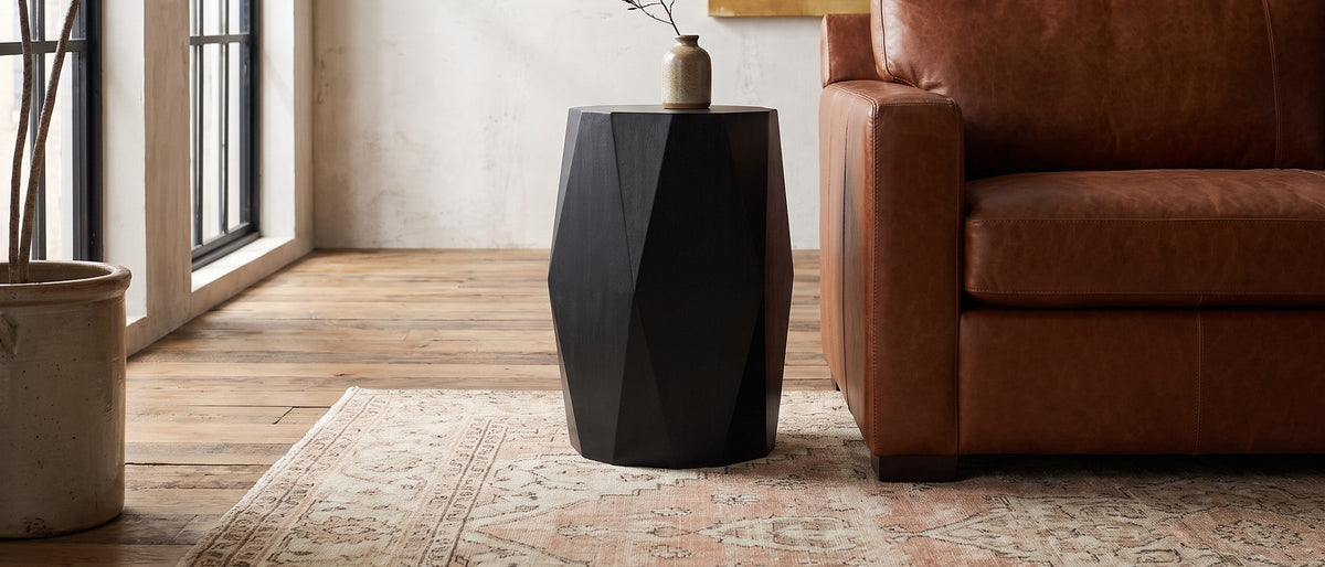 Miglionico Black Mango Wood Faceted Drum Side Table in the room