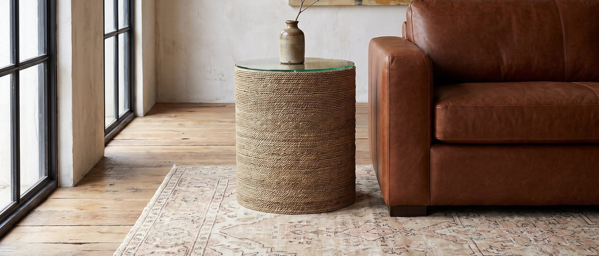 Montescaglioso Woven Seagrass Drum Side Table in the room