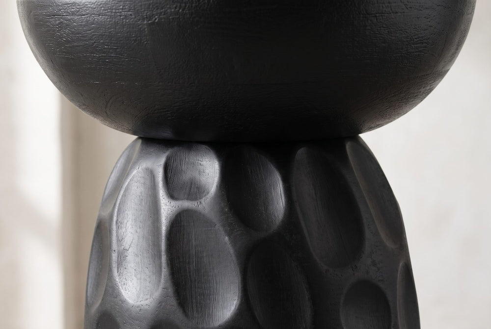 A bowl on a carved bell