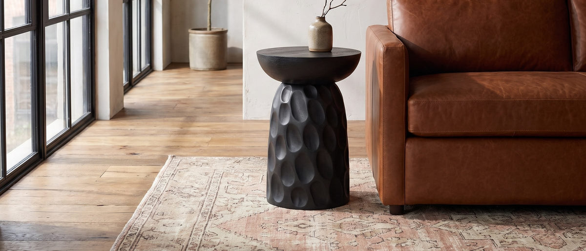 Olevano Carved Black Mango Pedestal Side Table in the room