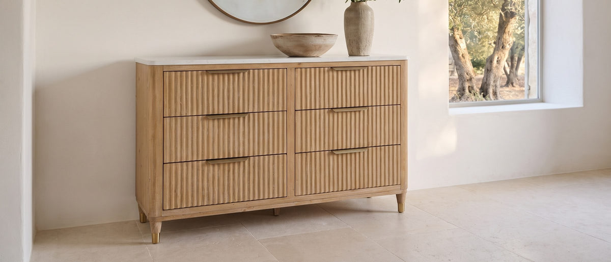 Palmanova 62-Inch Natural Wood and White Stone 6-Drawer Dresser in the room