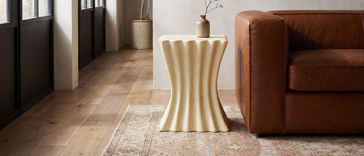 Racale Cream Fiberglass Pleated Side Table in the room