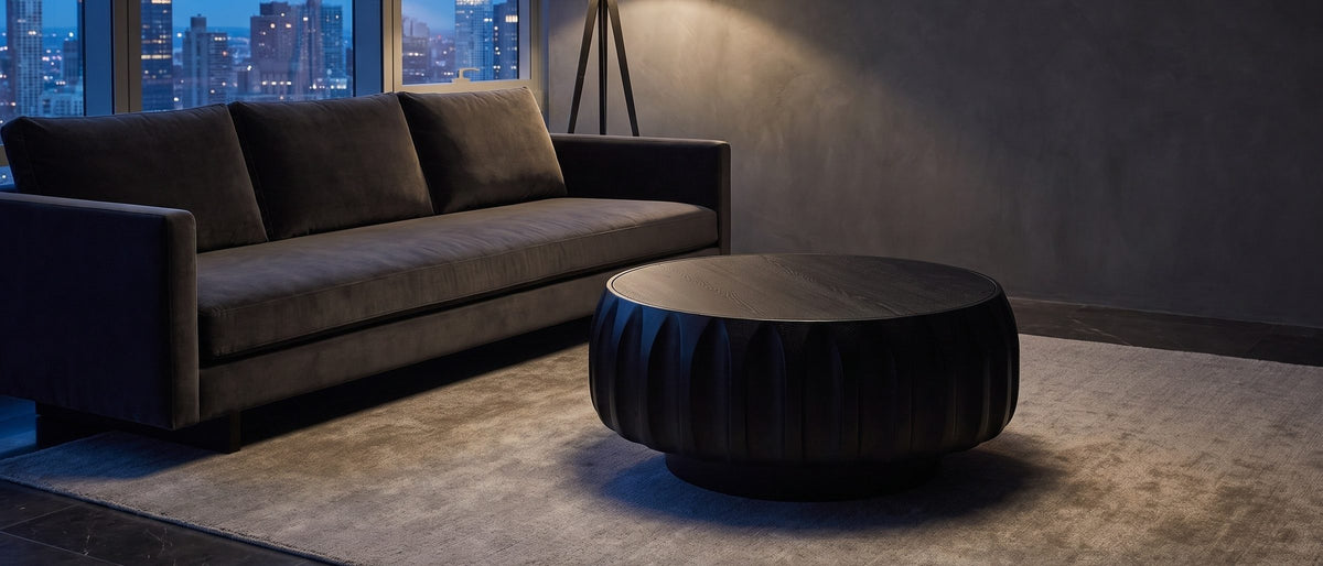 Radda Black Carved Wood Drum Coffee Table in the room