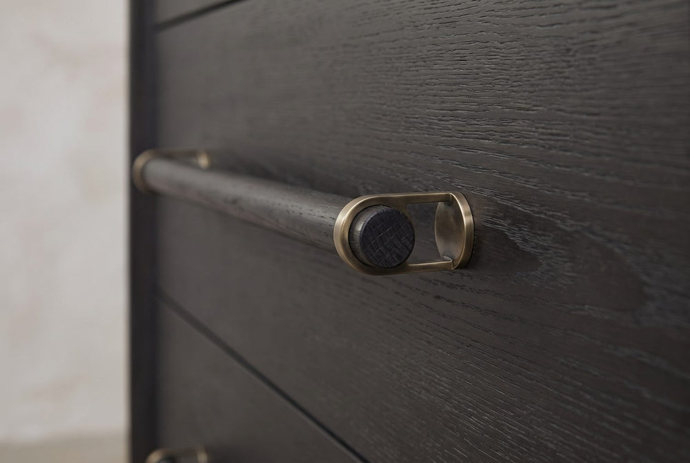 A dowel in a brass-tone loop