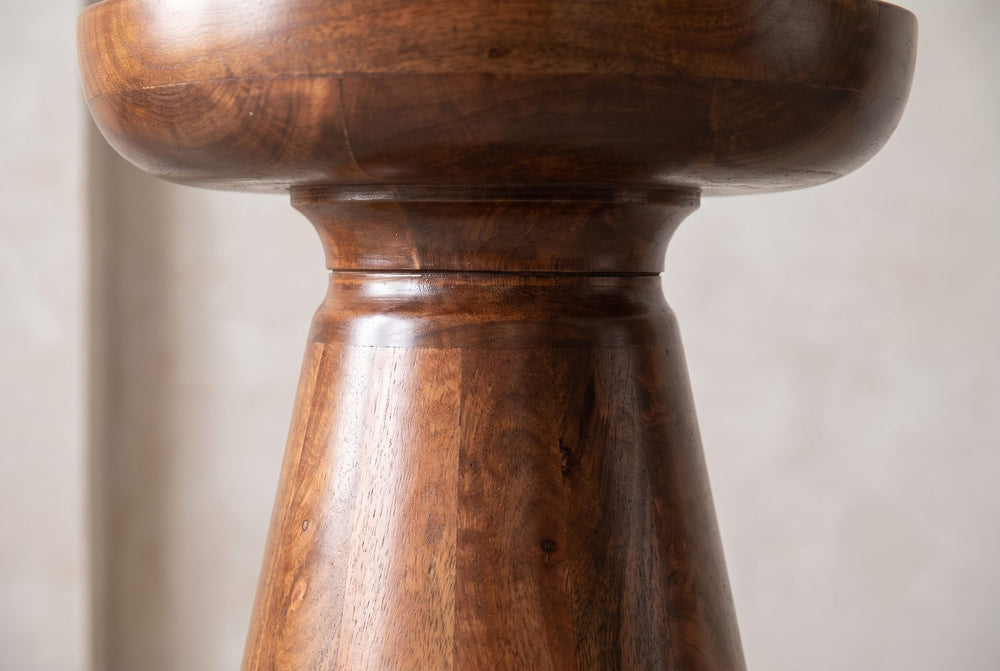A rounded cap on a turned neck