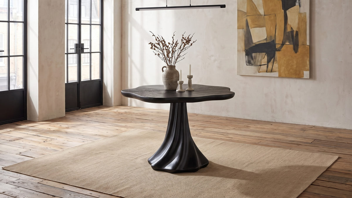 One dark form at the table. - Spilimbergo Black Fiberglass Twisted Petal Pedestal Dining Table