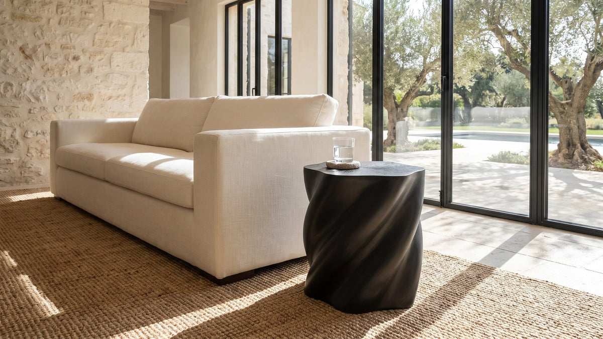 One dark shape in a pale corner. - Spilimbergo Black Fiberglass Twisted Petal Side Table