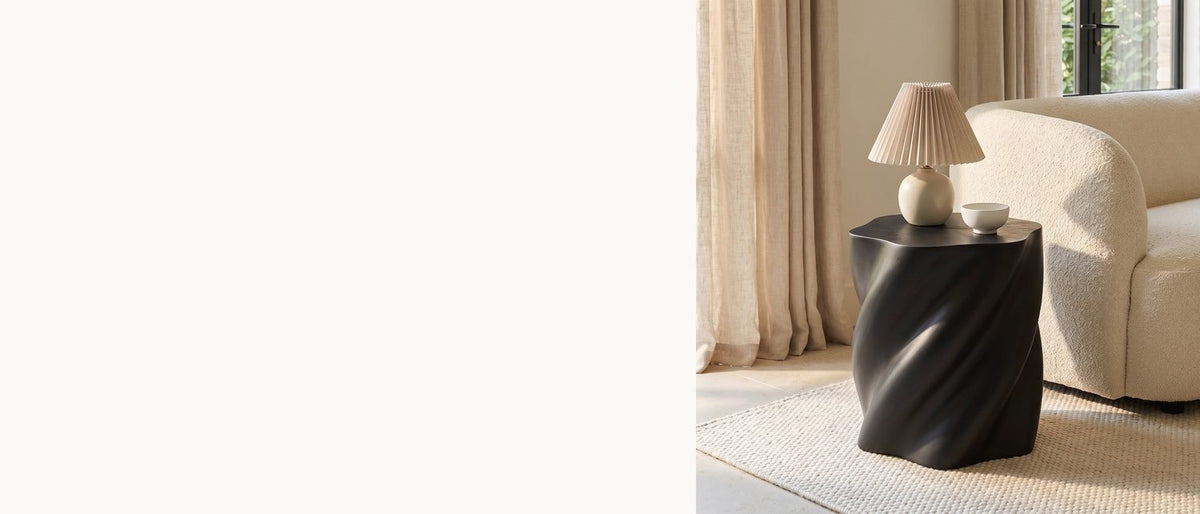 A black twist beside the sofa. - Spilimbergo Black Fiberglass Twisted Petal Side Table