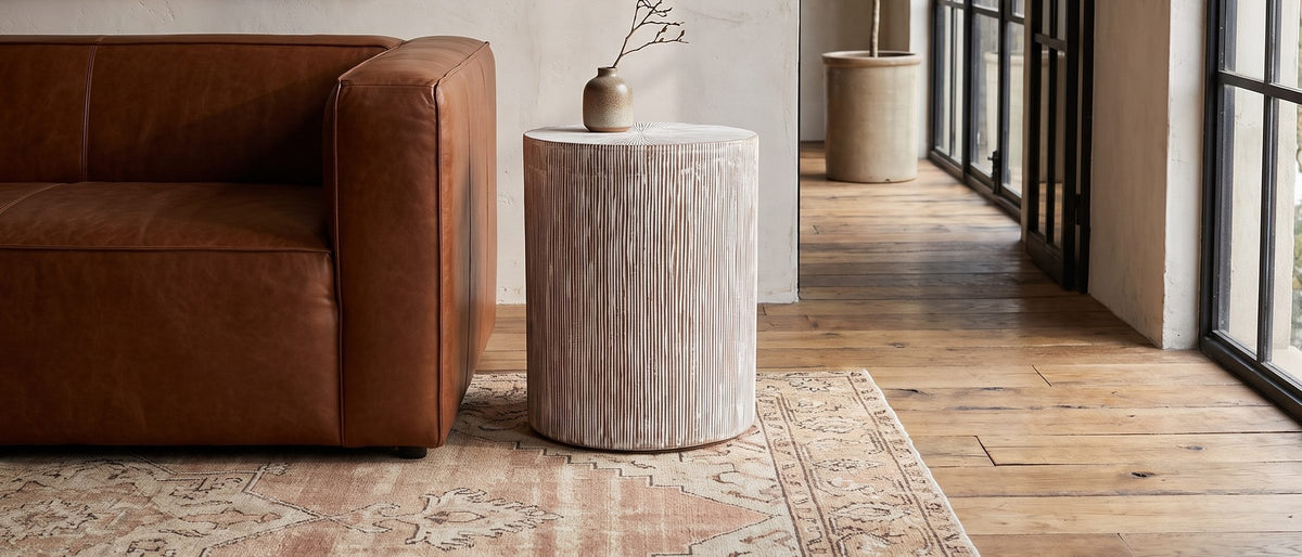 Tortora Carved Whitewash Drum Side Table in the room