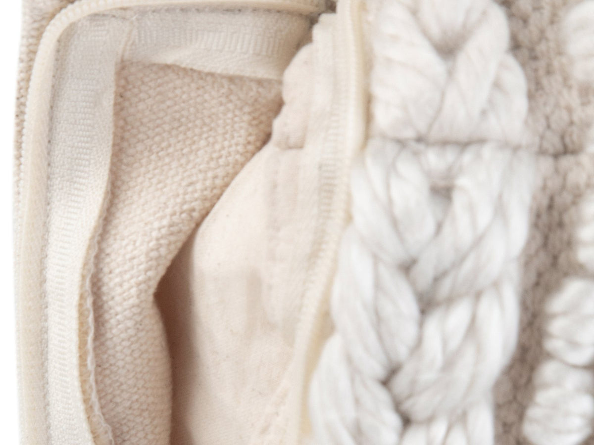 Close-up of the Apricale Natural Handloom Cotton Square Pouf: the zip along the bottom edge, opened