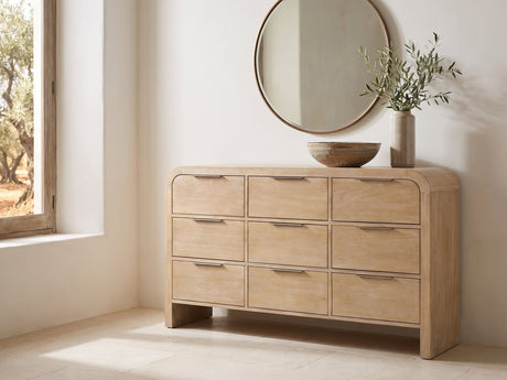 Aquileia 63-Inch Natural Mango 9-Drawer Dresser under a round bronze mirror in a villa bedroom