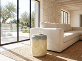 Aradeo Reactive Glaze Ceramic Drum Side Table beside a linen sofa in a poolside villa