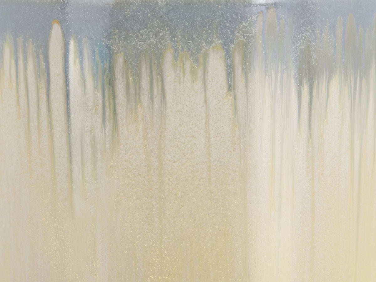 Close-up of the Aradeo Reactive Glaze Ceramic Drum Side Table: the reactive glaze running from blue-grey into cream